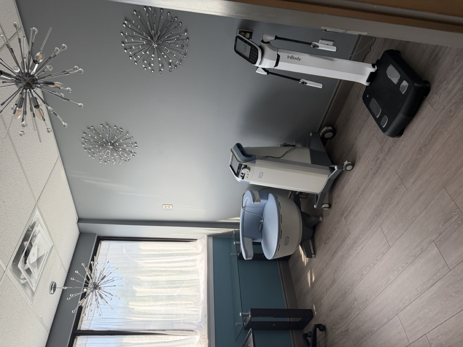 The InBody body composition analyzer and EMSELLA chair in a treatment room at Revitalize Your Health, Niagara Falls